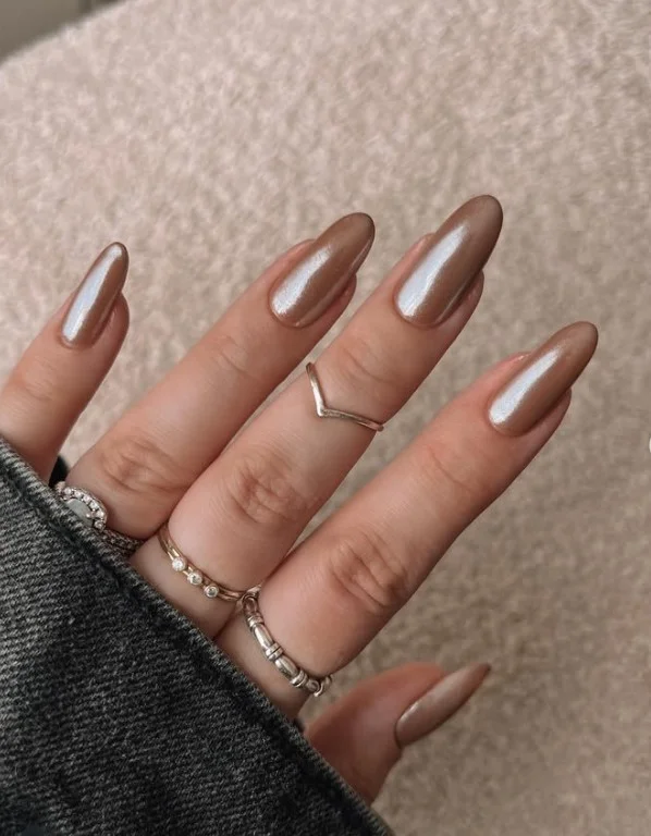 Cinnamon milk almond nails with warm brown shades and a glossy manicure.
