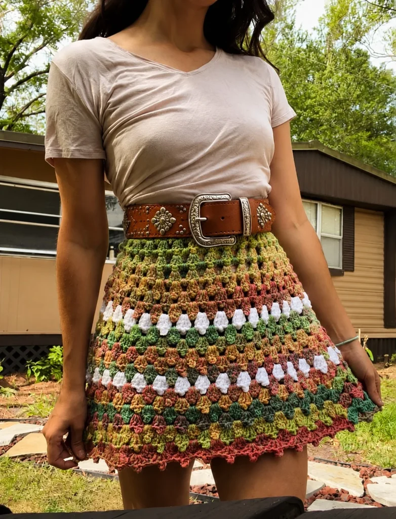 Crochet mini skirt outfit enhanced with statement belt fashion detail