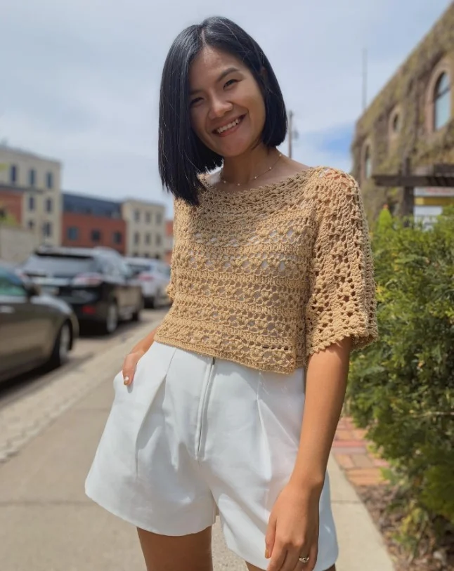 Crochet top styled with linen shorts for a relaxed vacation-inspired outfit.