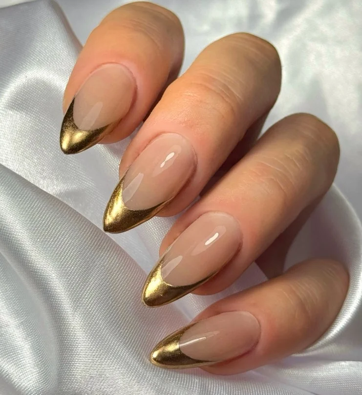 Beige elegant classy almond nail designs featuring delicate gold accents