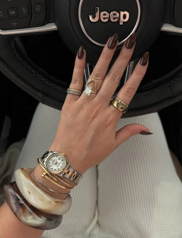 Dark brown almond nails in espresso shade with glossy finish and clean elegant style