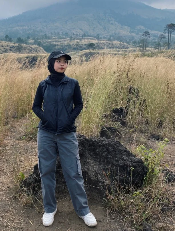 Outdoor hiking vest layered over a long sleeve trekking shirt for cool mornings.