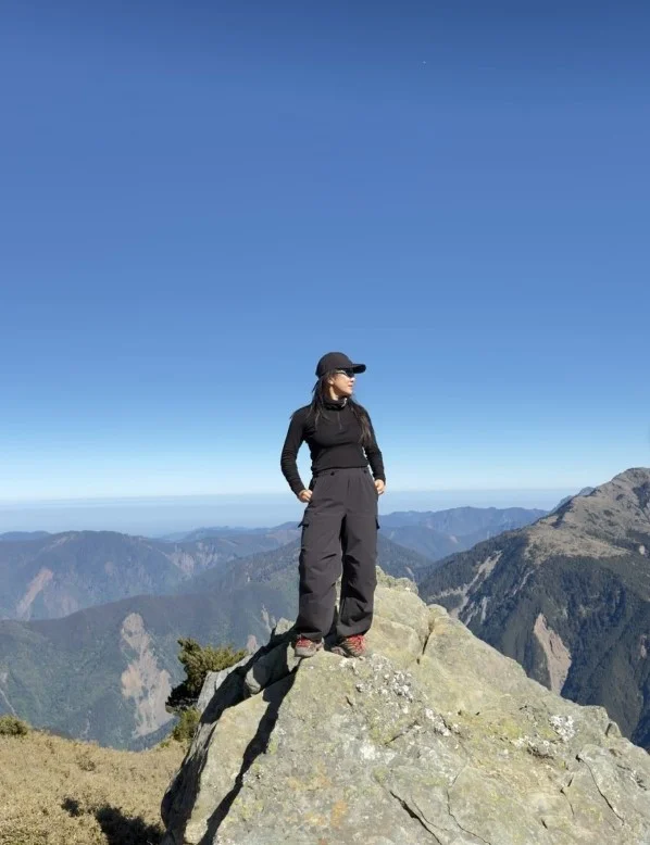 Lightweight fleece jacket styled with cargo hiking pants for a comfortable mountain trekking outfit.