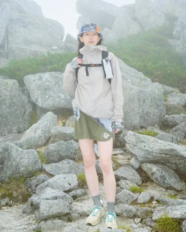 Packable rain jacket with hiking shorts for unpredictable mountain weather.