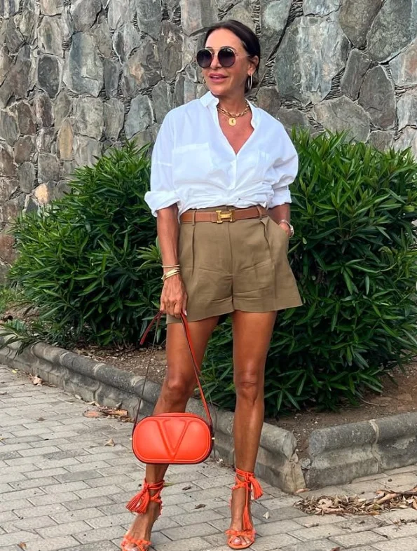 Woman wearing a linen button-up shirt with tailored shorts for an elevated summer outfit.