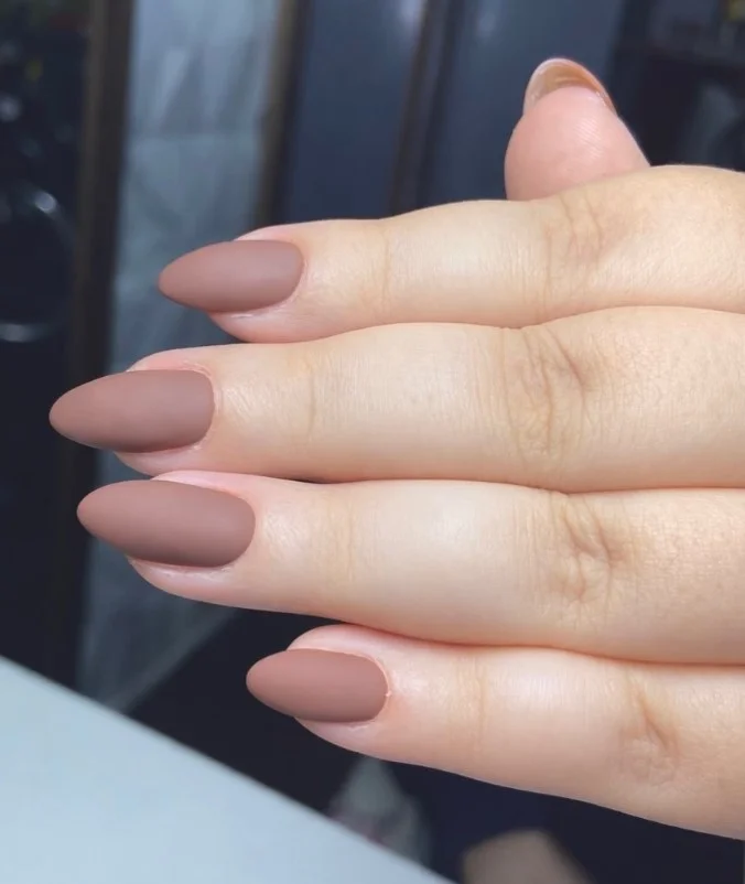 Matte latte almond nails featuring a soft brown neutral finish and minimal style.
