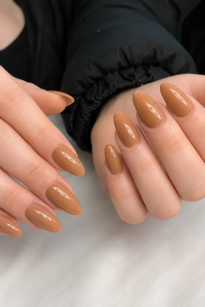 Milky caramel almond nail design featuring creamy light brown tones and a polished look.