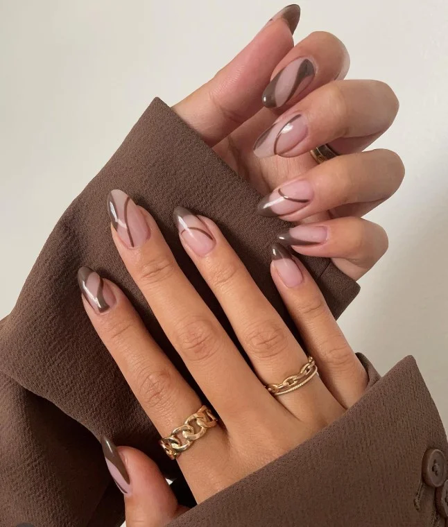 Light brown almond nails with modern minimalist line art nail design.