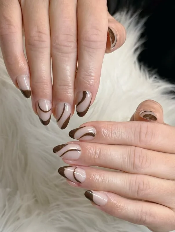 Simple brown almond nails with thin minimal line nail art.