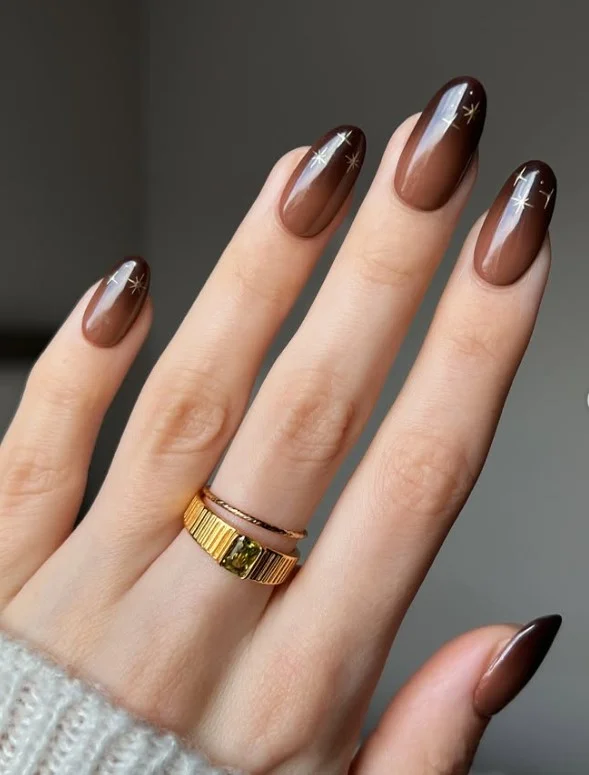 Soft ombre almond nails blending mocha and brown tones smoothly.