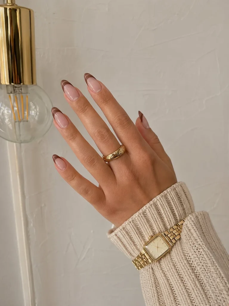 Modern negative space almond nails with light brown accents and clean lines.