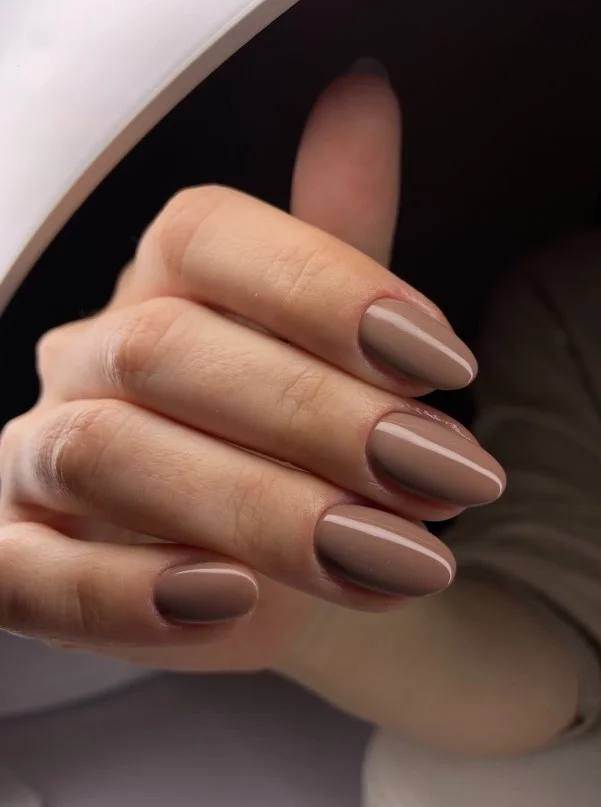 Nude mocha almond nail design with soft brown tones and elegant styling.