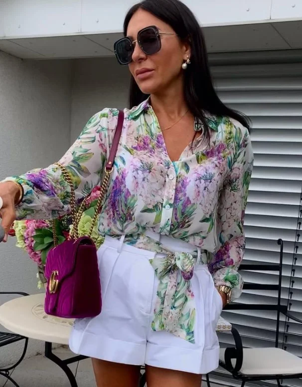 Elegant silk blouse paired with shorts for a sophisticated summer look.