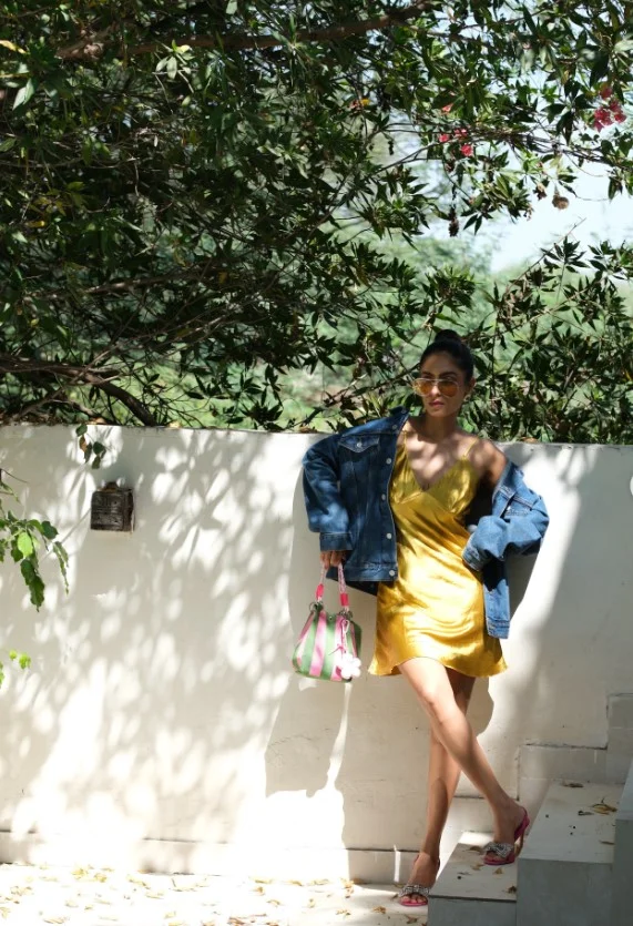 Silk slip dress styled with a blue denim jacket for a casual chic outfit.