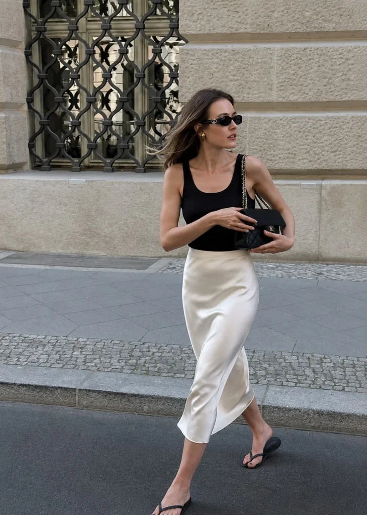 Silk slip skirt styled with a fitted tank top and sneakers.