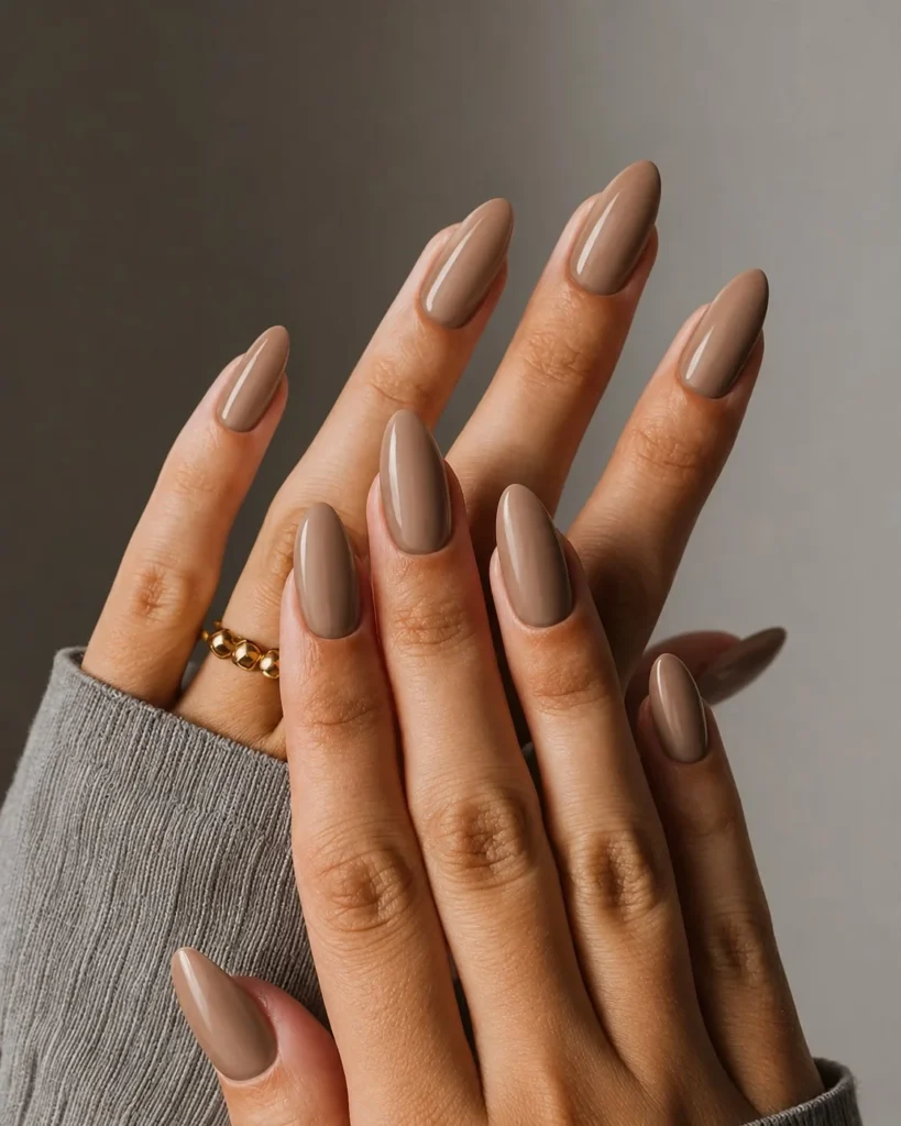 Soft beige almond nails with a natural light brown manicure and classy finish.