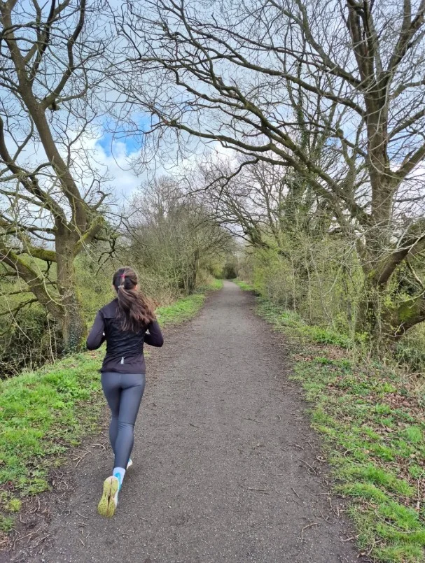 women trail running outfit with performance top and running leggings for cool weather