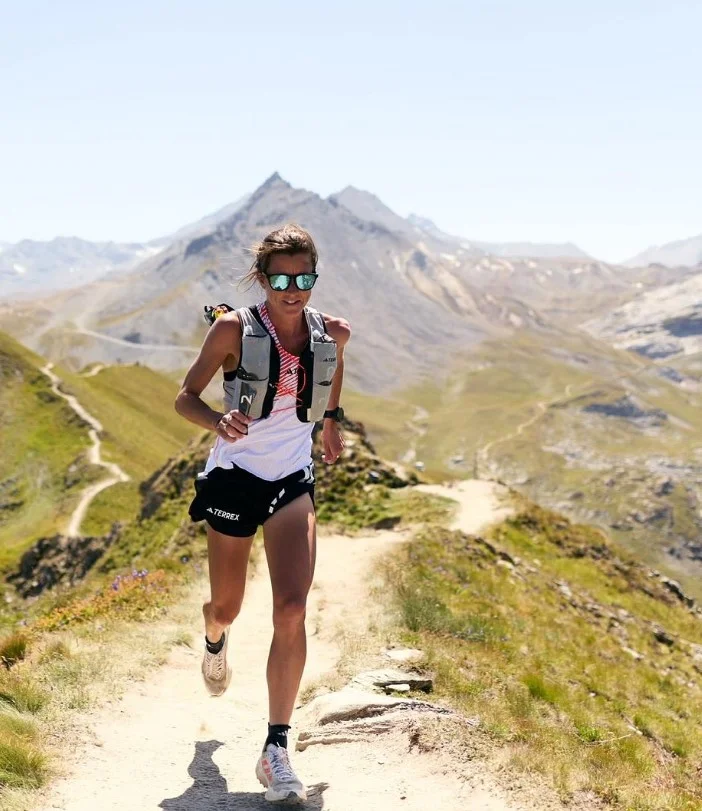 women mountain trail running outfit with weather resistant outdoor gear