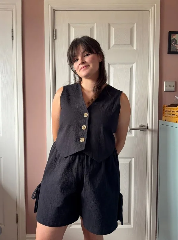 Matching waistcoat and shorts outfit with a modern tailored silhouette.