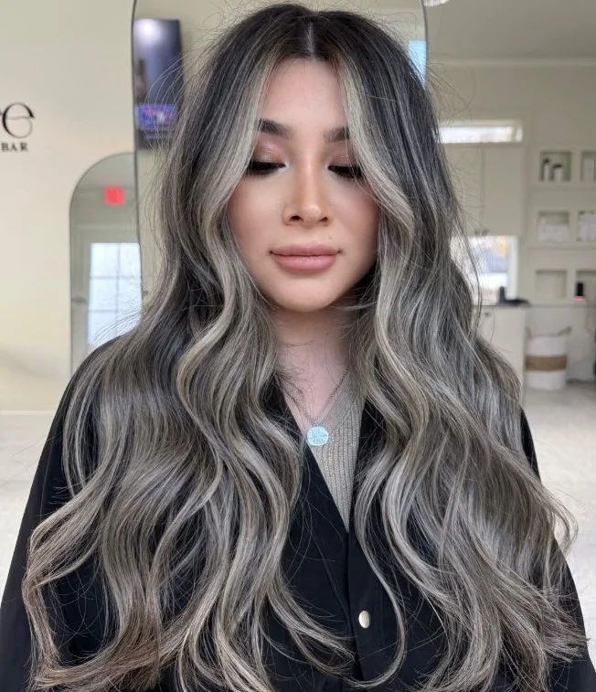 Ash blonde hair color with a cool smoky finish complementing pale skin.