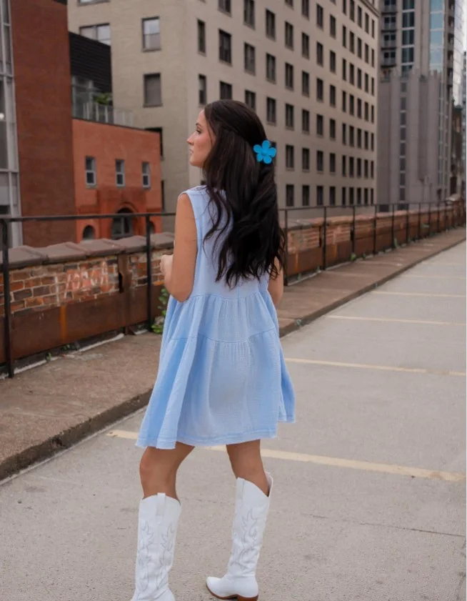 Baby blue dress outfit paired with white cowboy boots for a trendy western-inspired look.