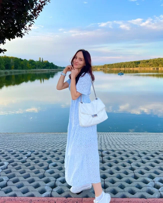 Baby blue dress outfit with white sneakers and a crossbody bag for a casual everyday look.