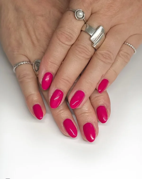 Berry pink nails adding a healthy glow to pale skin