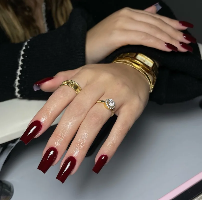 Classic burgundy nails creating elegant contrast on fair skin