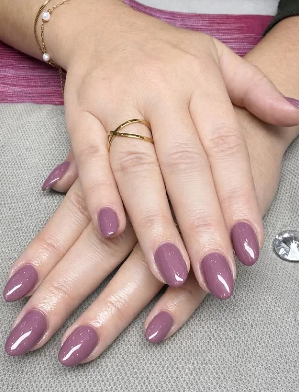 Cool mauve manicure complementing fair skin beautifully