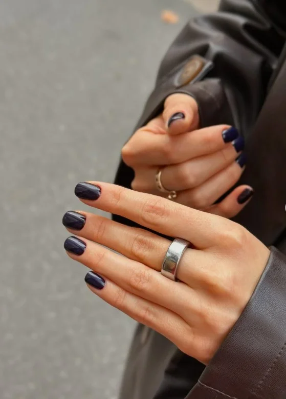 Deep plum manicure creating a rich elegant look on pale skin