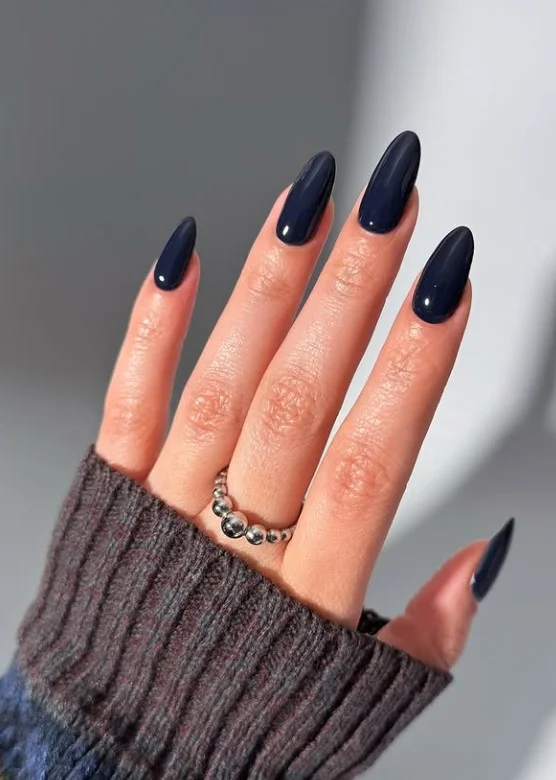 Navy blue nails adding bold contrast to pale skin