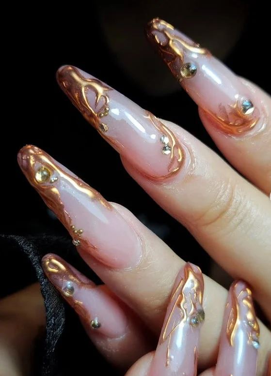 Bronze metallic nails enhancing the natural glow of tan skin