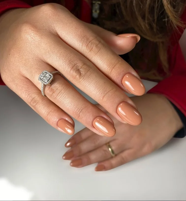 Caramel nude nails complementing warm tan skin beautifully