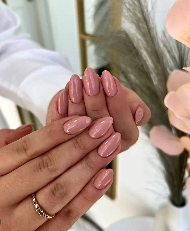 Champagne beige nails with a polished natural finish for tan skin