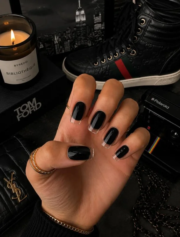 Glossy black nails creating a timeless manicure on tan skin