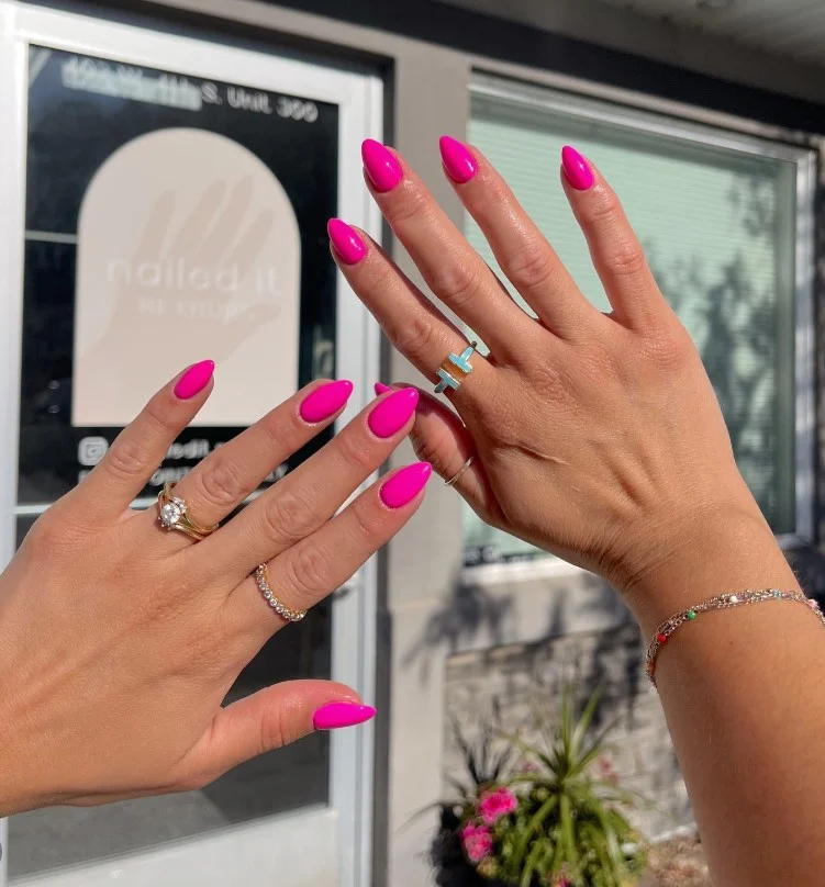 Hot pink nail polish standing out beautifully on tan skin