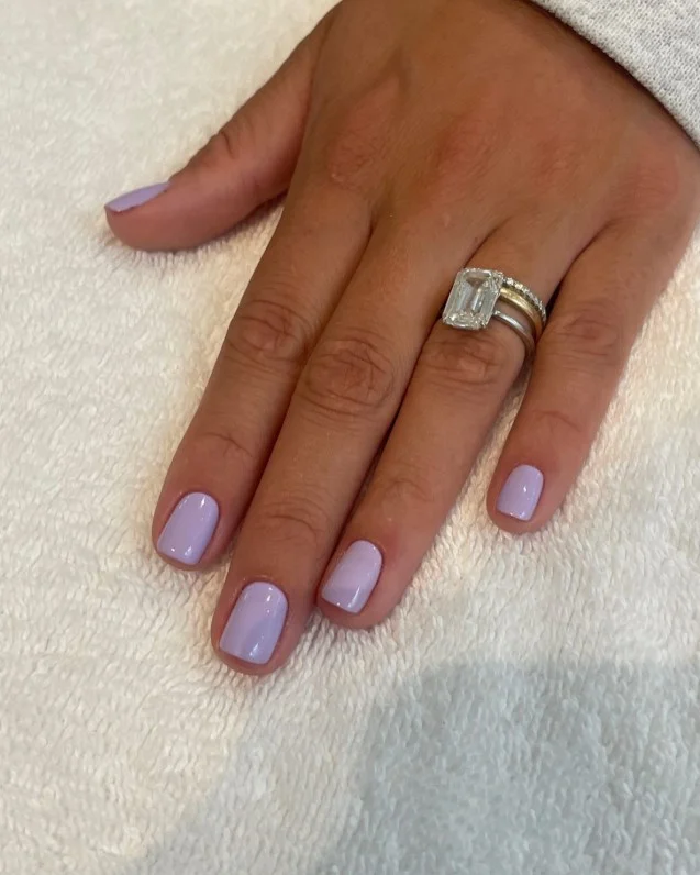 Soft lavender nail polish brightening tan skin beautifully