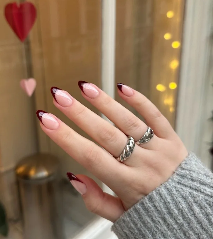 Burgundy French tip fall nail designs with sheer nude bases and elegant deep burgundy tips.