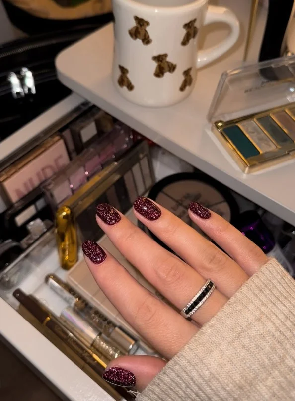 Burgundy fall nail designs with fine glitter accents creating an elegant seasonal sparkle.