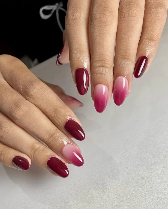 Burgundy ombre fall nail designs blending rich burgundy into nude for a seamless gradient effect.