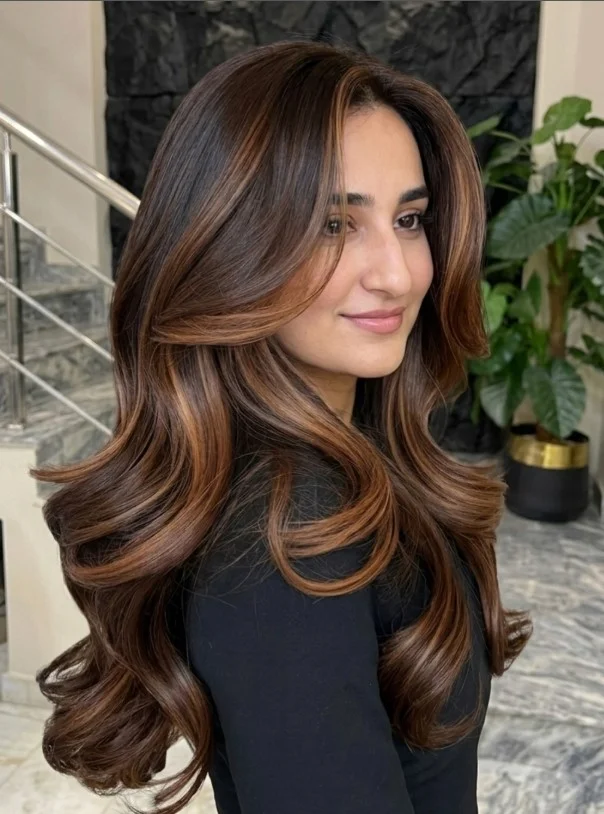 Caramel brown balayage adding warm dimension to hair against pale skin.