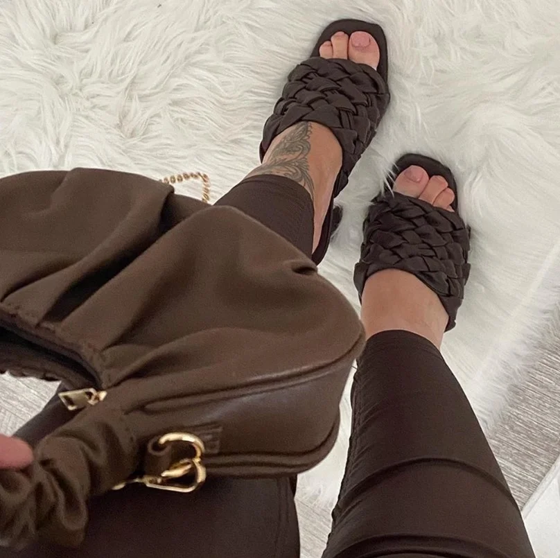 Chocolate brown heels creating a warm contrast with a black dress.