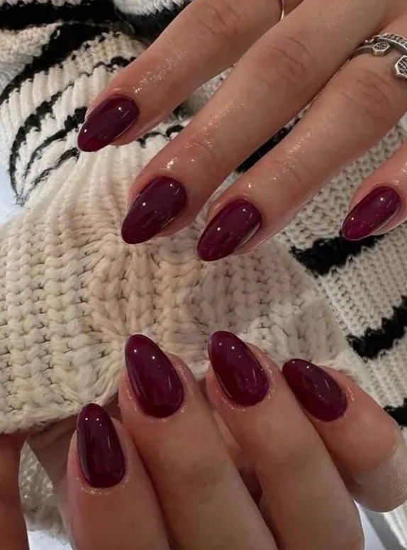 Classic cherry red nail designs with a rich high-gloss finish creating a timeless elegant manicure.