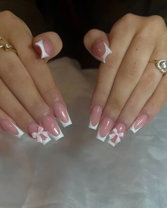 Cute coquette square nail designs featuring glossy polish with elegant 3D bow accents.