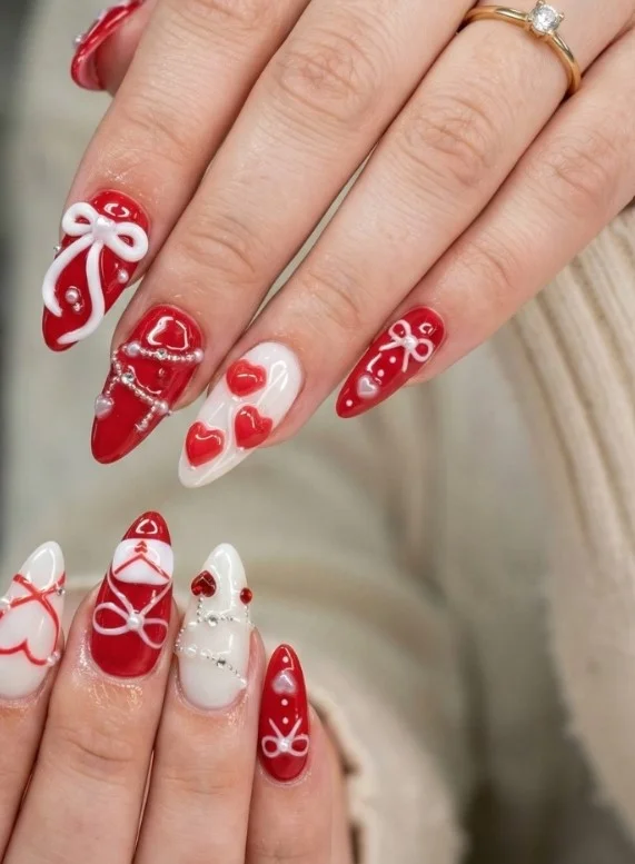 Long coquette nails featuring delicate 3D bow accents on sheer pink glossy nails.