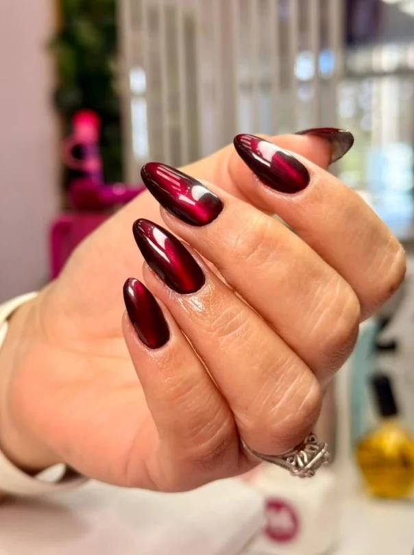 Red velvet cat-eye nail designs with a magnetic shimmer creating a luxurious multidimensional effect.