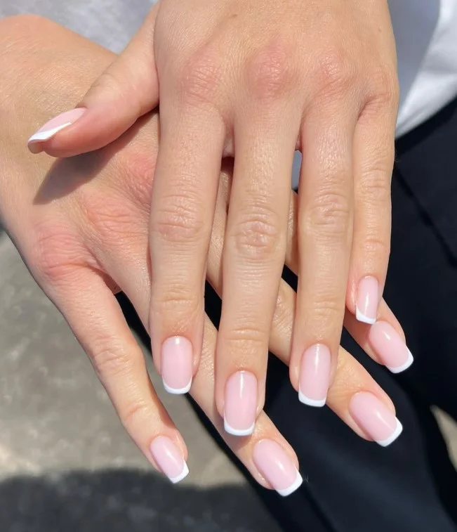 Cute square nail designs featuring milky pink nails with clean white French tips and a glossy finish.