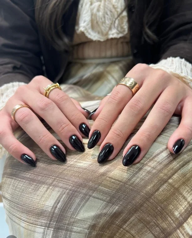 Deep plum manicure complementing a plum-colored formal dress.