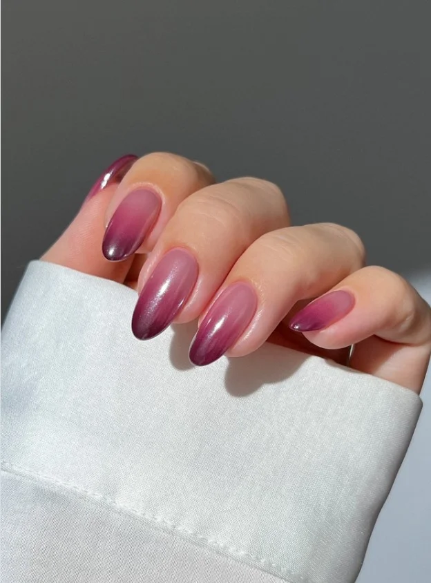 Deep wine red ombré nail designs blending smoothly into a natural nude base with a glossy finish.