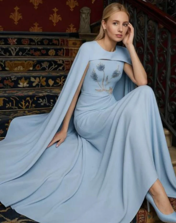 Dusty blue chiffon prom dress with graceful cape sleeves and flowing skirt